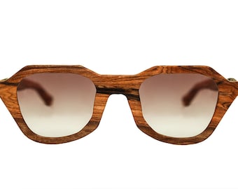May include: A pair of brown wood-framed sunglasses with gradient brown lenses.