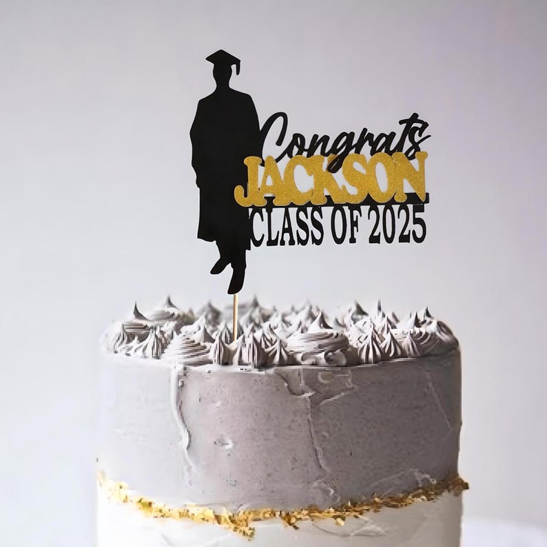 May include: Black and gold graduation cake topper with a silhouette of a graduate, the text "Congrats Jackson Class of 2025", and a stick for inserting into a cake.