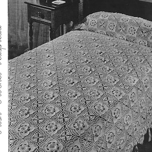 May include: A white crocheted bedspread with a floral pattern. The bedspread is on a bed with a white pillow.
