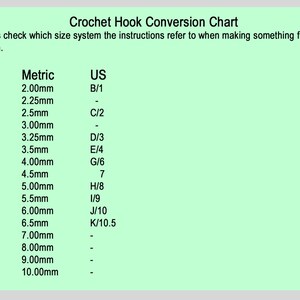 May include: A crochet hook conversion chart with UK, Metric, and US hook sizes listed in columns. The chart shows the corresponding hook sizes for each system, with measurements in millimeters.