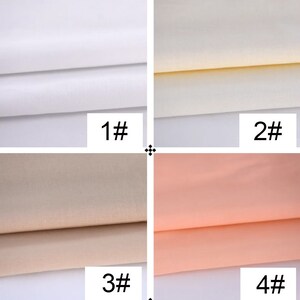 May include: Four fabric swatches in different colors: white, off-white, beige, and peach. The swatches are folded in half and labeled with numbers 1 through 4.