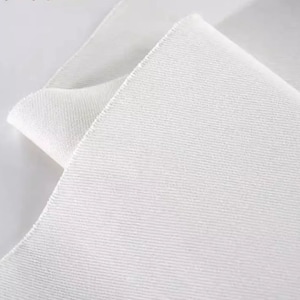 May include: White fabric with a textured surface. The fabric is folded over itself, showing the underside of the fabric.