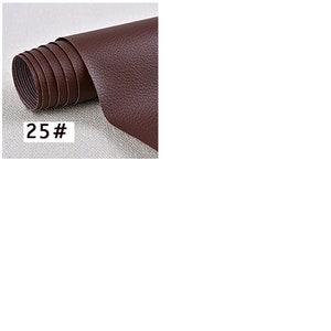 May include: A roll of brown faux leather fabric. The fabric is textured and has a subtle grain. The roll is labeled "25#"