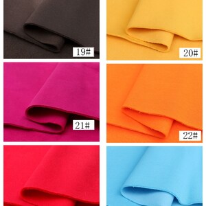 May include: Six fabric swatches in different colors. The swatches are arranged in two rows of three. The colors are brown, yellow, pink, orange, red, and light blue. Each swatch has a number printed on it, from 19 to 24.