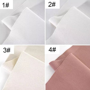 May include: Four fabric swatches, each showing the front and back of the fabric. The swatches are in the following colors: white, off-white, cream, and dusty rose.
