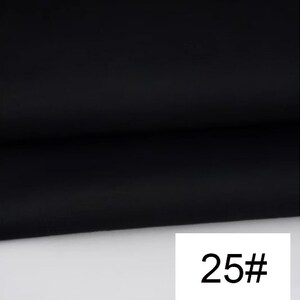 May include: Black fabric swatch with the number 25# printed on a white background.