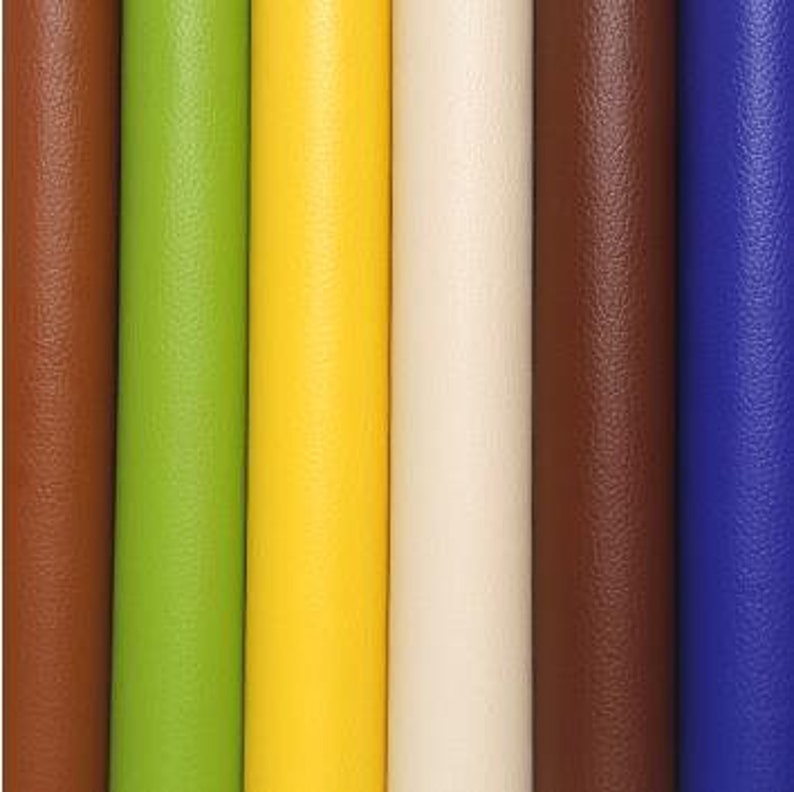 May include: Five rolls of faux leather fabric in different colors: brown, green, yellow, cream, and blue.