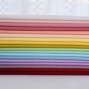 May include: A stack of 18 fabric swatches in various pastel colors, including white, pink, peach, yellow, green, blue, lavender, and red.