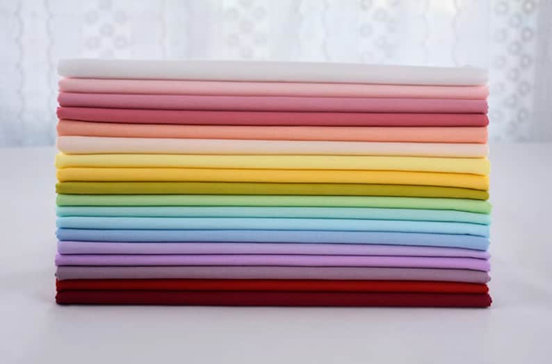 May include: A stack of 18 fabric swatches in various pastel colors, including white, pink, peach, yellow, green, blue, lavender, and red.