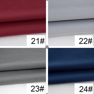 May include: Four fabric swatches, each folded in half. The swatches are labeled 21#, 22#, 23#, and 24#. The swatches are burgundy, light gray, dark gray, and navy blue.