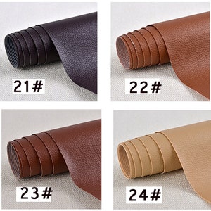 May include: Four rolls of faux leather fabric in different colors: dark purple, brown, dark brown, and beige. The rolls are labeled with numbers 21, 22, 23, and 24.