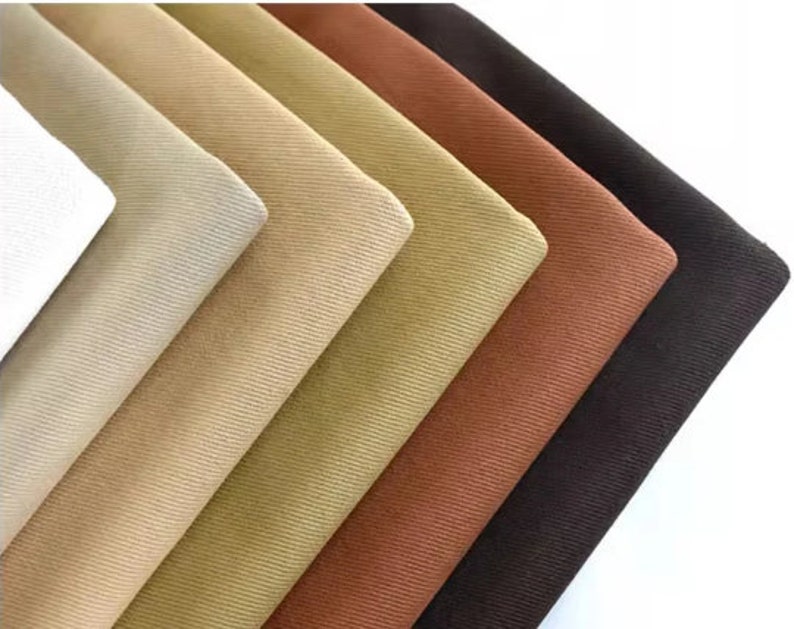 May include: A collection of fabric swatches in various shades of brown, beige, and white. The fabric has a corduroy texture.