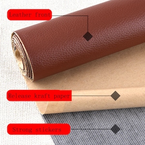 May include: A roll of brown leather with a textured surface. The leather is backed with a brown release kraft paper and strong stickers.