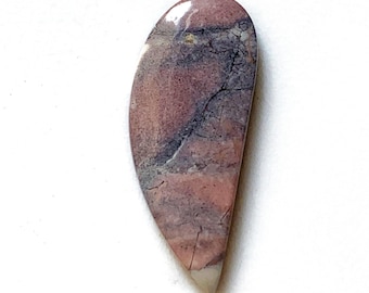 May include: A polished, teardrop-shaped gemstone with a mix of pink, gray, and white hues. The stone has a glossy finish and displays natural veining and patterns, creating a unique appearance. The gemstone is likely used for jewelry or decorative purposes.