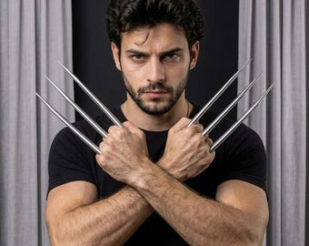 May include: A set of six long, pointed, silver-colored metal blades held in a crossed position. The blades are slender, tapered, and metallic, extending outward from the hands. The object is displayed against a dark background with grey curtains.