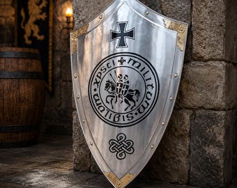 May include: A polished silver heater shield featuring a black iron cross at the top, a central circular emblem depicting two figures on horseback with the text Sigillum Militum Xpsti, and a decorative knotwork design at the bottom with gold accents.