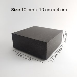 May include: A black granite cube measuring 10 inches by 10 inches by 4 inches. Size: 10 cm x 10 cm x 4 cm.