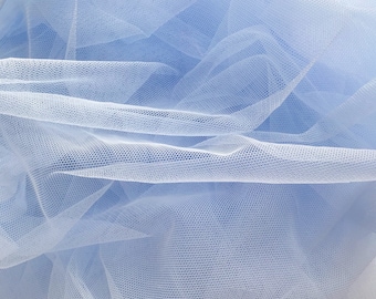 May include: A close-up of light blue tulle fabric. The fabric is soft and delicate, with a fine mesh weave.