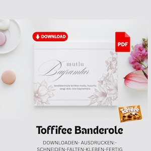 Può includere: Una scatola bianca con la scritta "mutlu Bayramlar" e illustrazioni floreali. L'immagine include un pulsante rosso "DOWNLOAD", un'icona "PDF" e una scatola di caramelle Toffifee. È visibile anche il testo "Toffifee Banderole".