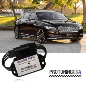 May include: Black power pack with the text "POWER PACK QUICK CONNECT TURBO TUNER" and "PROTUNINGUSA WWW.PROTUNINGUSA.COM" on it. The power pack is connected to a black wire harness. The power pack is in front of a black Lincoln sedan.