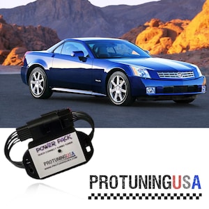 May include: A blue Cadillac XLR convertible parked in front of a desert landscape. A black electronic device with the text "POWER PACK QUICK CONNECT TURBO TUNER PROTUNINGUSA WWW.PROTUNINGUSA.COM" is in the foreground.