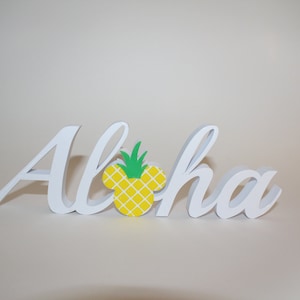 May include: White wooden sign with the word "Aloha" in cursive lettering. A yellow pineapple with green leaves is in the center of the sign, shaped like a Mickey Mouse head.