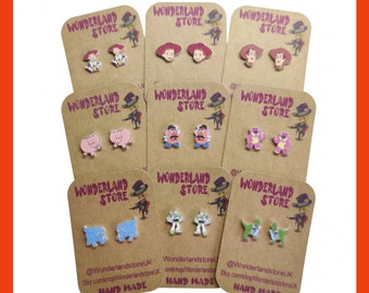 May include: Nine pairs of handmade wooden earrings featuring characters from the Toy Story movie franchise. The earrings are displayed on brown cards with the text "Wonderland Store" and social media handles.