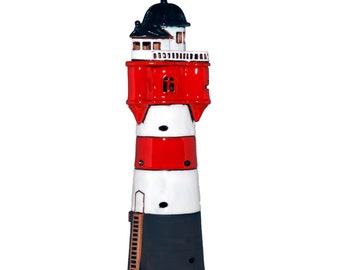 May include: A decorative lighthouse figurine with a black, red, and white color scheme. The lighthouse features a black dome, red midsection, and white and black base. A small ladder is visible on the side. The figurine is approximately 12 inches tall.