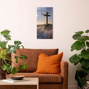 May include: A glass clock featuring a wooden cross on a mountaintop with fog and a sunrise in the background.