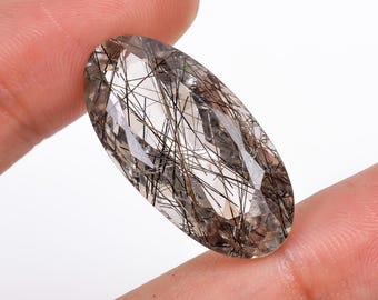 Piedra tallada ovalada de cuarzo rutilado negro de 24 quilates, 28 x 14 x 10 mm.