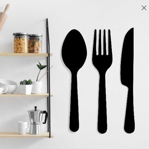 Puede incluir: Silueta negra de una cuchara, un tenedor y un cuchillo sobre un fondo blanco.