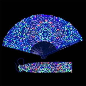 May include: A black folding fan with a blue, green and purple iridescent pattern. The fan has a black handle and is decorated with a mandala design. The fan comes with a matching iridescent fabric pouch.