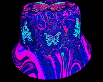 May include: A vibrant bucket hat with a swirling pattern in shades of blue, pink, and purple. The hat features multiple butterfly designs in neon green and pink. The hat is designed to glow under black light.