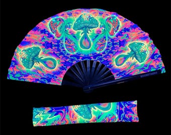 May include: A vibrant, psychedelic hand fan with a matching wristband. The fan features a colorful mushroom design in shades of blue, green, pink, and purple. The fan's frame is black. The wristband mirrors the fan's design. The text "SICKWEETSMERCH" is visible on the fan.