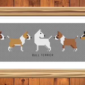 May include: A cross-stitch pattern featuring five different colored Bull Terriers in a row. The text "BULL TERRIER" is printed below the dogs.