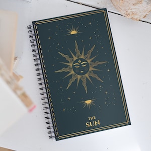 The Sun Tarot Card Journal with a Witchy Aesthetic Gold and Blue Tarot Blank Spiral Notebook