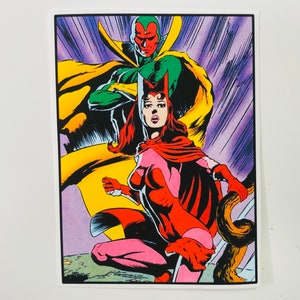 May include: A comic book illustration of Scarlet Witch and Vision. Scarlet Witch is wearing a red and pink costume with a red cape. Vision is wearing a green and yellow costume with a yellow cape. The background is purple with streaks of yellow and white.