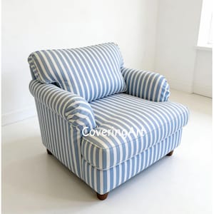 May include: A blue and white striped armchair with a cushioned back and armrests. The chair has a classic design with wooden legs. The fabric features vertical stripes, creating a nautical or coastal theme. The chair is a comfortable seating option.