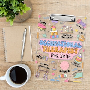 May include: A clear clipboard with a silver clip, featuring colorful illustrations and text related to occupational therapy. The words "OCCUPATIONAL THERAPIST Mrs. Smith" are prominently displayed. Other text includes "SOCIAL", "FINE MOTOR", and "COGNITION".