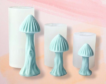 May include: Three silicone molds for making resin mushroom ornaments. The molds are white and the mushrooms are light blue.
