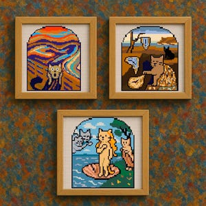 May include: Three framed cross-stitch artworks featuring cats in famous art parodies. One depicts a cat in "The Scream," another in a Dali-esque landscape, and the third as Venus. The frames are wooden, and the background is a textured, multi-colored wall.