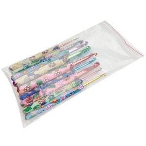May include: A set of 10 colorful crochet hooks with patterned handles. The hooks are arranged in a plastic bag.