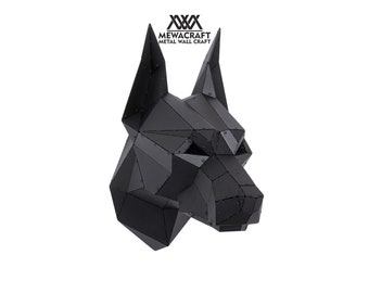 May include: Black metal sculpture of a dog's head, with a geometric design. The sculpture is made of many small, flat pieces of metal that are welded together. The sculpture is mounted on a white wall.