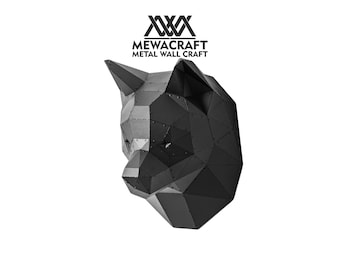 May include: Black metal sculpture of a wolf's head, a geometric design with a 3D effect.  MEWACRAFT METAL WALL CRAFT is printed below the sculpture.