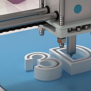 May include: A 3D printer in operation, printing the letters "3D" in white plastic on a blue platform.