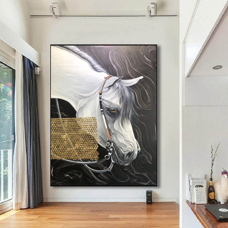 May include: A painting of a white horse with a black bridle and gold accents on a black background.