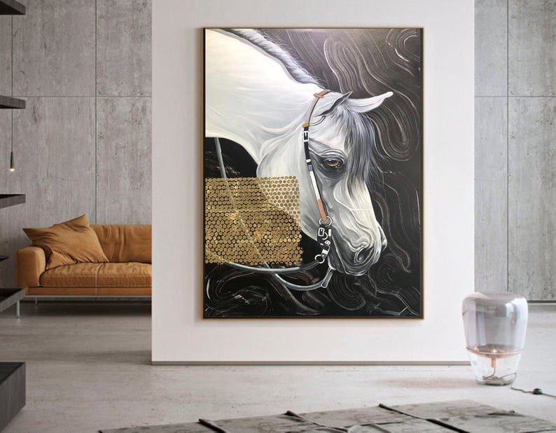 May include: A painting of a white horse with a black background. The horse's head is turned to the side, and its mane is flowing in the wind. The horse is wearing a bridle and a bit. The painting is framed in a gold frame.