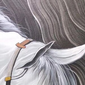 May include: Close-up of a white horse's head with a brown leather bridle. The horse's mane is flowing and the background is a dark gray.