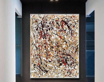 May include: Abstract painting with a white background and black, red, and brown paint splatters. The painting is framed in a thin, silver frame and is hanging on a wall in a hallway.