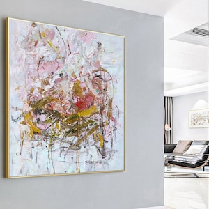 May include: Abstract painting with pink, white, and brown colors. The painting has a textured surface and is framed in gold.
